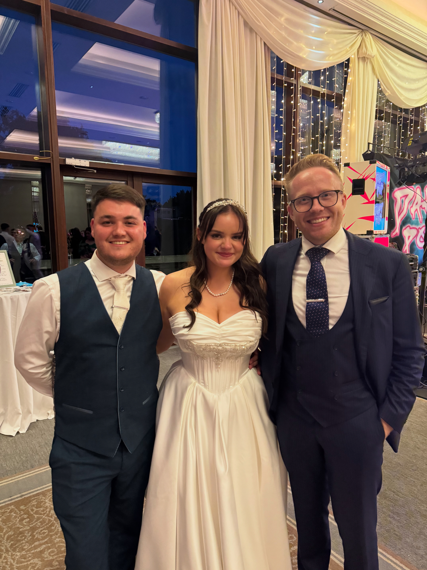 Bride and groom with Kristian Grey at their evening wedding reception